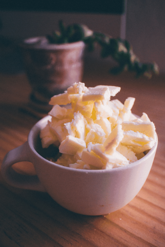 "Homemade body butter made with shea and cocoa butter placed in a wooden bowl for intense winter skincare | skincaresolutions.in